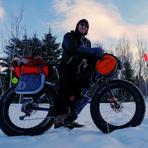 Jeff Oatley meets Brent Sass near the end of the Yukon Quest trail in Whitehorse on Monday.
