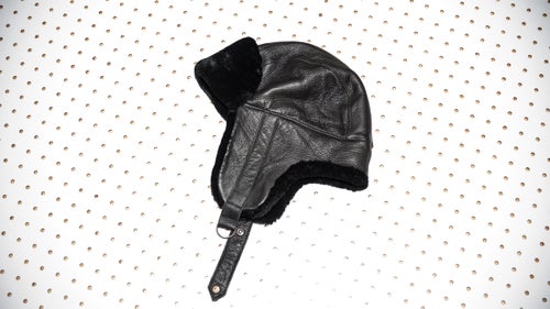 Pilots used to wear caps like the Garren to keep them warm high above the clouds. Made from leather, cotton, and shaved lamb fur, the hat features earflaps that fold up on warmer days and down when the snow starts to fly.