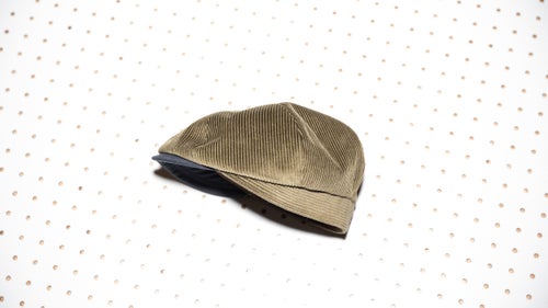 The Brawler, handmade in Nashville, Tennessee, uses a wide-wale cotton corduroy for heat retention, and the six-panel fit sits at a just-rakish-enough angle to channel Newsies without becoming a full-on period piece.