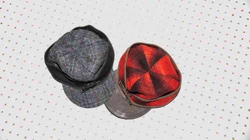 The classic Stormy Kromer cap (right), born from blustery Wisconsin winters, lets you slide the headband down over your ears when temperatures drop. This version has the classic red and black wool outer and a Horween leather brim. Also pictured: the Original Cap with Harris Tweed ($60).