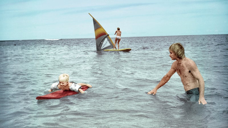 Healey surfing with his father on Oahu, 1982.