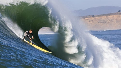 Santa Cruz native Nic Lamb races down the face of a Maverick's wave.