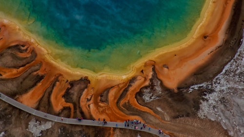 Garrett Fisher’s day job is executive director of the Institute for Economic Innovation, a think tank he founded, but he spends nearly as many hours on his passion project: flying his blue and yellow Piper PA-11 Cub Special plane over mountains, glaciers, and grasslands, cracking open the pilot-side window, reaching his arm out with Canon EOS Rebel SL1 in hand, and snapping some of the most beautiful aerial landscape shots we’ve seen. The plane is nearly 70 years old, has no heating system, and flies slowly, all of which make for an uncomfortable ride in varied terrain and bad weather. “I usually go alone,” Fisher says. “People always end up puking.” Fisher, who’s been flying since he was 16, scouts locations by exploring random points of interest on Google Earth or a U.S. Geological Survey map. Then he’ll spend up to 13 hours a day in the air (with fuel stops every three hours), focusing on capturing photos that serve as art and resource. His photos can serve as message (he’s shot receding glaciers at Glacier National Park, among others) or reference (he’ll overlay a composite image of every single 14er in Colorado with a map, for example, which is useful as a “mountaintop-perspective” guide for hikers). “I’m looking for an interesting integration of ground to horizon to sky,” he says. In February, he moved from Alpine, Wyoming, to Germany (“maybe for good”) and will put his energy into capturing Europe from the air. We asked for the stories behind some of his favorite—or most hard-won—images so far. Photo: Grand Prismatic Spring, Yellowstone “For hot spring imagery, the angle of photography completely changes. Instead of trying to tie sky, texture, and land into a subject, I am trying to peer into the heart of the hot spring, cutting through steam and reflections on the water, isolating everything else out of the image. It is a dance requiring a zoom lens and about six passes over the area to achieve a suitable focus and angle.”