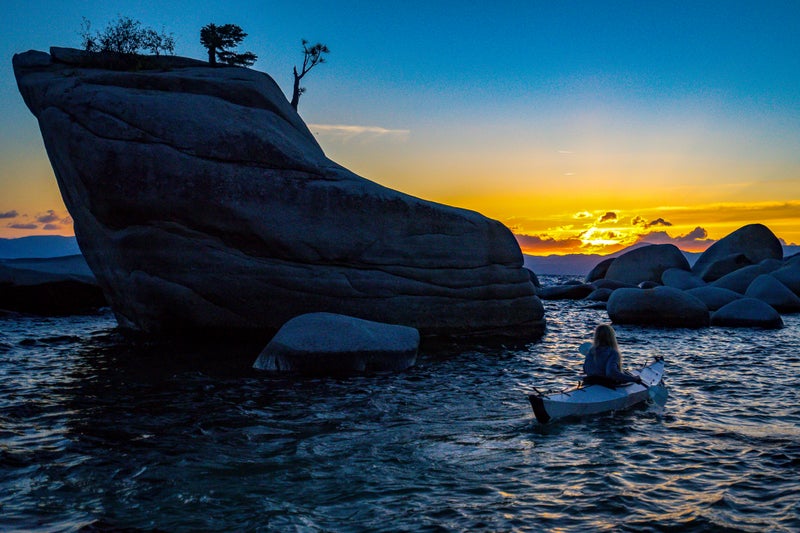 Valerie paddles the Oru on Lake Tahoe at sunset.