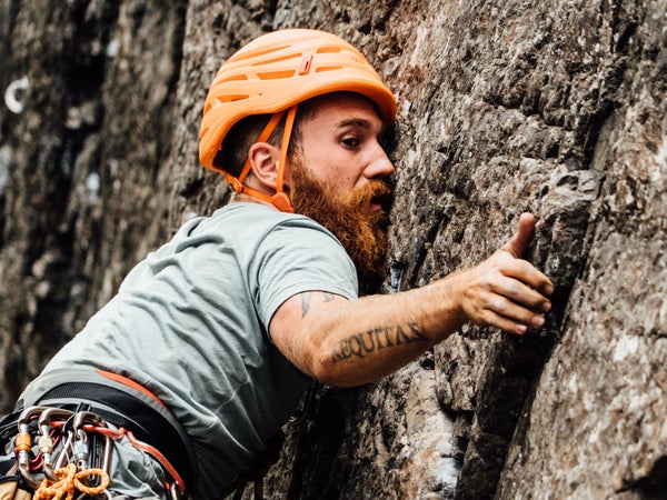 man leading a route outdoor rock climbing