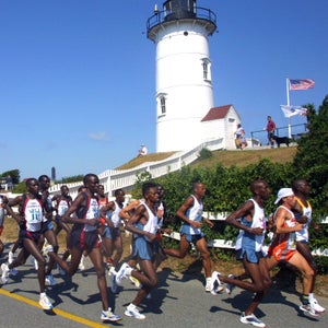 Frontrunners pass Nobska Point Lighthouse during the 30th annual Falmouth Road Race in Falmouth, Ma., Sunday, Aug. 11, 2002.  Kenyans John Korir and Lornah Kiplagat were the first man and woman to cross the finish line.  (AP Photo/Julia Cumes)