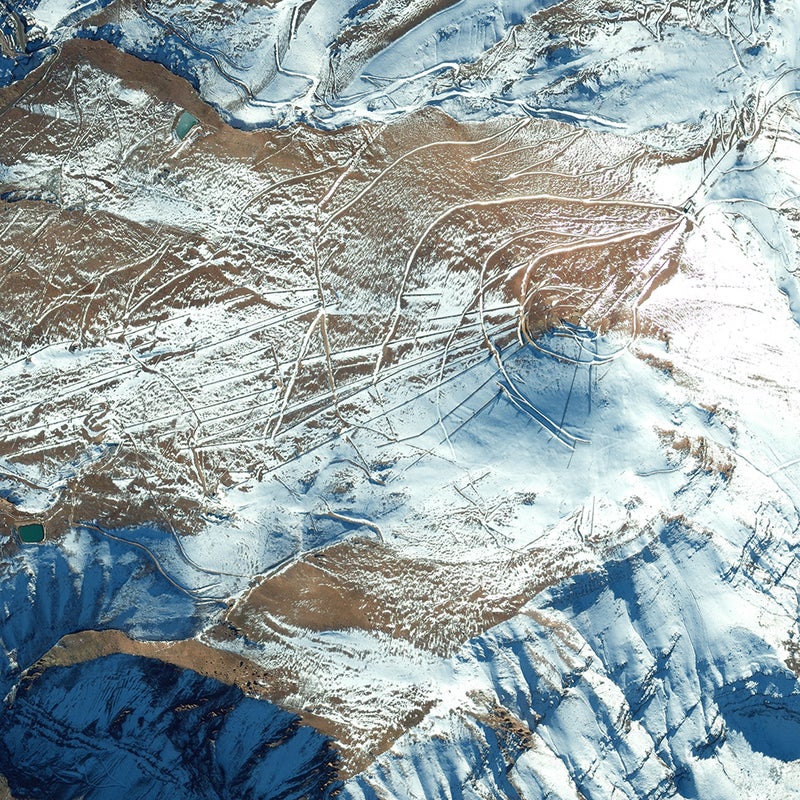 This May 2013 image shows the cat track winding around the conical slopes of Chile’s El Colorado, the closest ski area to Santiago (about a one-hour drive). El Colorado slopes lie between two other Andean resorts, La Parva (visible on the photo’s upper margin) and Valle Nevado. The three are interconnected by a series of lifts and, all told, comprise the Tres Valles ski area, with 7,000 skiable acres, 40 chairlifts, and four base villages.