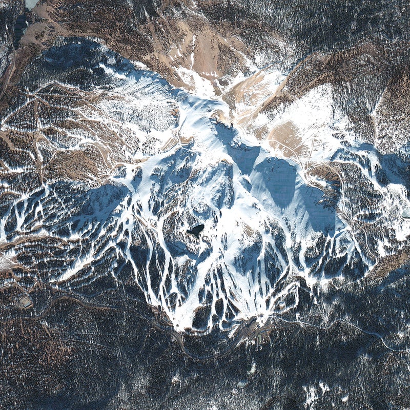 11,053-foot Mammoth Mountain’s 3,500 skiable acres were photographed from the northeast in December 2008, showing off the massive, tentacled system on the peak’s lee side. (The windward side is scraped clean by fronts coming off of Mammoth Pass, in the upper lefthand corner of the photo). The winter of 2008-2009 wasn’t one of Mammoth’s epic snow seasons—the mountain gets an average of 400 inches of snow each year—but the 470 inches of snow was enough to extend skiing there until July 4, 2009. The dark body of water halfway up the mountain is the resort’s snowmaking reservoir.