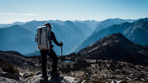 Gilberto Gill stands atop the Sierra High Route. With thru-hiking becoming overly popular, similarly challenging, and scenic, backpacking trails are attracting adventure seekers.