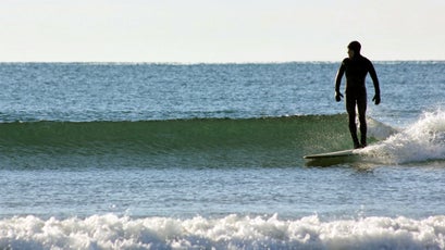 Winter surfing requires commitment. You'll need as thick a wetsuit as you can afford, and an even thicker set of gloves and boots. Pack a thermos full of warm water to pour inside your suit when you get out of the water, and be prepared to shake and shiver for 30 minutes no matter what.