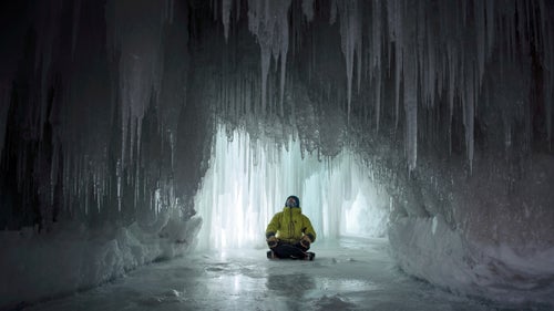 Jon Jugenheimer, a local ice climber and organizer for the production, sits in what the crew called the Ballroom: a cave covered in tiny icicles, situated on the side of the cliffs.