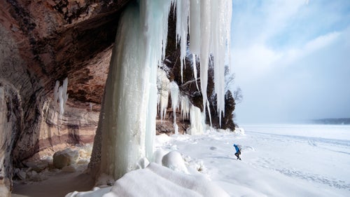 Kyle Rott, one of the climbers who helped to rig during the production, walks up to set a route on a massive ice pillar.