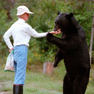 Kay Grayson feeds peanuts to a bear she named