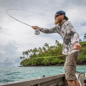 I traveled to Samoa in late March for a week of exploratory fly fishing with Australian professional angler Jonathan Jones. Both of us were hopeful about the fishery—it looked promising on maps, with wide, sweeping flats dropping off steeply past the reef edge to cuts that just look fishy. I confess to getting a little giddy on the turbulence-ridden airplane ride in from Auckland.
Halfway through the week, we were less than happy. The fishery, as it turned out, was largely fished-out. Sometimes it happens; Jonathan and I have both fished around the world enough to know this. But, damn, it’s not fun when it does.
We made the most of it, putting in long hours on the flats and in the blue water. By the end of the week, we had a few fish to hand, but, as is so often the case, the true value of the trip was meeting new people and exploring a gem of a country. Jonathan went home to the Great Barrier Reef to chase fish in waters he knows. I returned home to Montana and spent a solo day on my favorite stretch of home water, where a fat rainbow trout grabbed my fly on the third cast. 
Photo: Jungle and ocean—there’s not much in between. Jonathan casts out in the channel between the two islands that comprise Samoa (Upolu and Savai’i), where little islands dot the open waters of the Pacific. After bringing up a few mahi-mahi in deeper water, we move to a reef edge in hopes of hunting up a few giant trevally. Nearby storm cells had offered a bumpy ride further out, but nestling between small islands the ride—and the casting opportunities—improve.