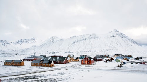 Ny-Ålesund settlement, Svalbard. The research center staff represents 11 countries including the UK, France, Germany, Norway, India, South Korea, and several others primarily focused on climate research.