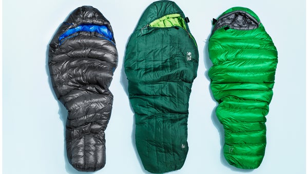 closeup of three sleeping bags on plain background