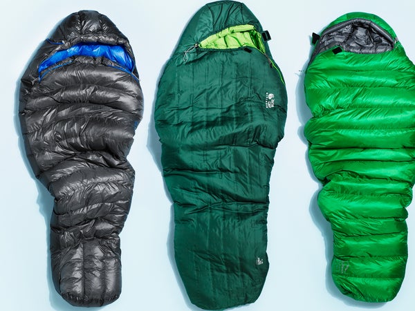 closeup of three sleeping bags on plain background