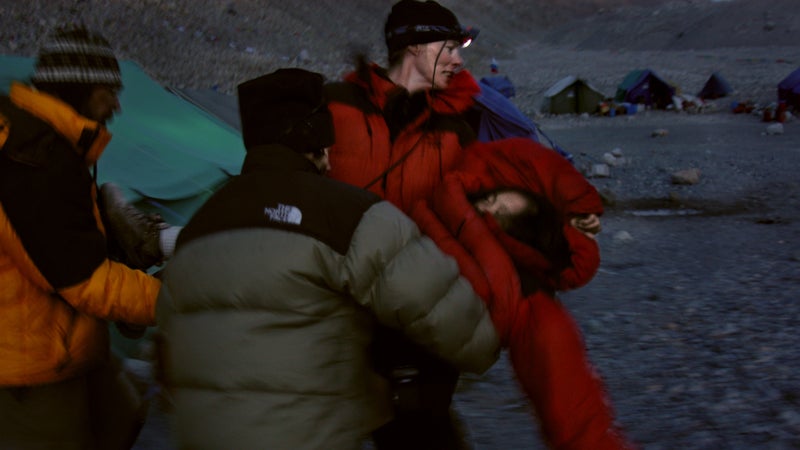 Carolyn Moreau, Anne Parmenter, and Chuck Boyd carry Lhakpa Sherpa to the team's dining tent after an altercation with Dijmarescu on Everest in 2004.