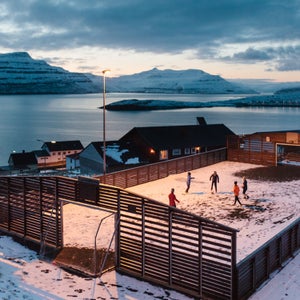 Children playing football in the village of Nes, Faroe Islands. March 2016.