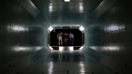 The secret to speed can be found in a nondescript building just north of San Diego off I-5. For the past 69 years, companies have tested the aerodynamics of their planes and missiles in the city鈥檚 wind tunnel. Now cyclists use the facility, too, with the goal of finding the ideal equation that maximizes speed while minimizing power output. Earlier this year, U.S. pro bike team Rally Cycling visited the wind tunnel with three of its top time-trialists鈥擱ob Britton, Adam de Vos, and Evan Huffman鈥攖o dial in their body positions before the season鈥檚 big races, including this week鈥檚 Tour of California. The team spent a day in the tunnel under the guidance of HED Cycling aerodynamics guru Dino Edin, who adjusted each riders鈥 ergonomics and cockpit mechanics. Here鈥檚 an inside look at that process.
Photo: Wind tunnel testing is a science of millimeters. It involves incremental adjustments to a rider鈥檚 position and the bike components.