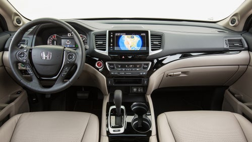 The cockpit in the Ridgeline feels like it belongs in a car, not a truck. The touchscreen you see here goes away in the base model, but even then, the cabin is sharper than what Toyota or Chevy offer in their introductory models.