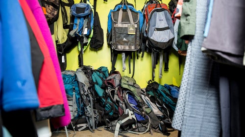 Various used backpacks line the wall at the Repair Lair. The store will also repair mailed-in gear.