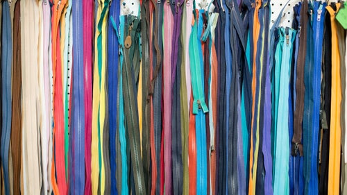 A colorful array of zippers hangs on the wall in the shop.