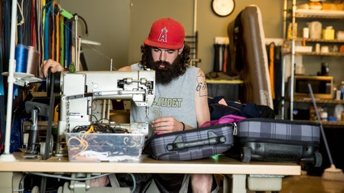 Alex Jacobson repairs a suitcase.
