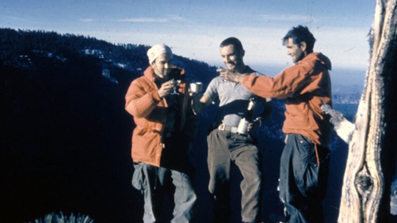 George Whitmore, Wayne Merry, and Warren Harding toast each other on the summit of the Nose. November 1958.