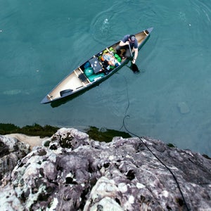 Exploring the Ozarks by way of the Buffalo River Released. Male exploring the Ozarks in his canoe on the Buffalo River in Arkansas.