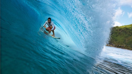 Jameson Kaeo Newtson, a local surfer, riding a wave off the western coast of Tutuila.