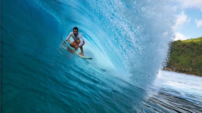 Jameson Kaeo Newtson, a local surfer, riding a wave off the western coast of Tutuila.