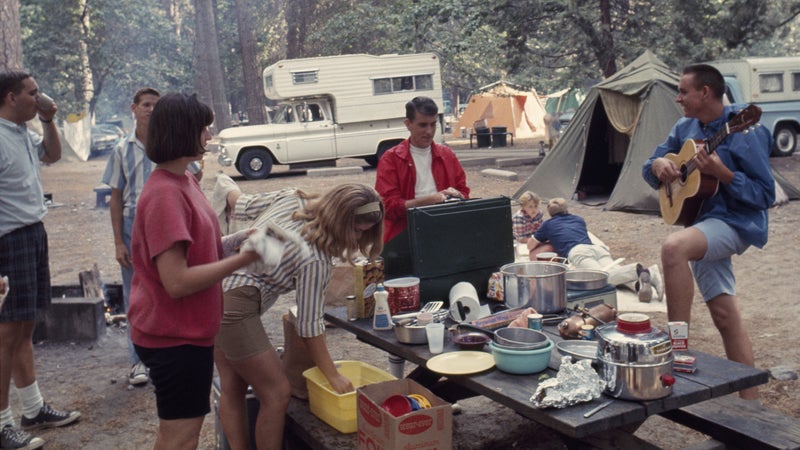 UNITED STATES - JULY 01:  Man plays guitar as friends stand around pot-laden picnic table; Yosemite National Park, California  (Photo by B. Anthony Stewart/National Geographic/Getty Images)