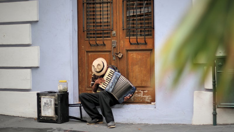 A plan plays an accordion in old San Juan.