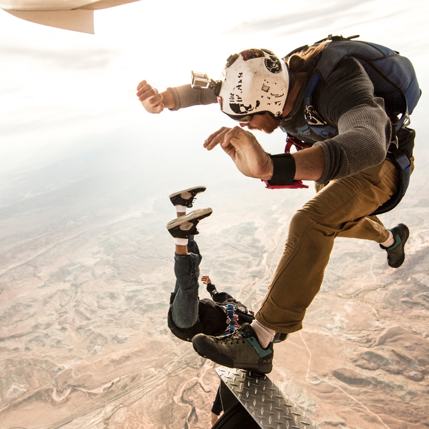 Adam Krum (top) and Nicholas Reyes of Skydive Moab taking flight above canyon country.