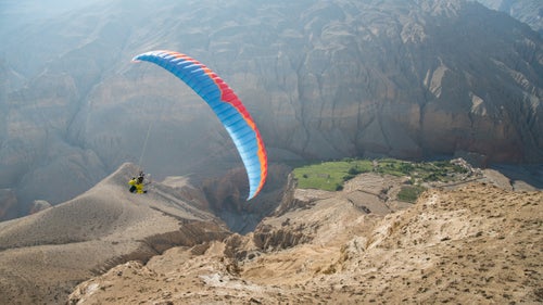 Last month, five friends set out from Pokhara, Nepal with mini-paragliders and 1950’s Royal Enfield motorcycles on a ten-day mission to the once forbidden Kingdom of Mustang in Tibet. The group of seasoned athletes and travelers made up of Nick Greece, Jamie and Isabella Messenger, and Cody and Cherise Tuttle, didn’t finalize their plans until a week out, which was kind of of the point. They wanted an adventure and a good ol’ figure-it-out style trip. Half the group was relatively new to paragliding—the other half was new to motorcycling. The table was set for some memorable experiences. Here, photographer
