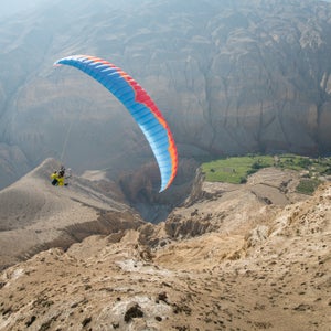 Last month, five friends set out from Pokhara, Nepal with mini-paragliders and 1950’s Royal Enfield motorcycles on a ten-day mission to the once forbidden Kingdom of Mustang in Tibet. The group of seasoned athletes and travelers made up of Nick Greece, Jamie and Isabella Messenger, and Cody Tuttle, didn’t finalize their plans until a week out, which was kind of of the point. They wanted an adventure and a good ol’ figure-it-out style trip. Half the group was relatively new to paragliding—the other half was new to motorcycling. The table was set for some memorable experiences. 
Here, photographer