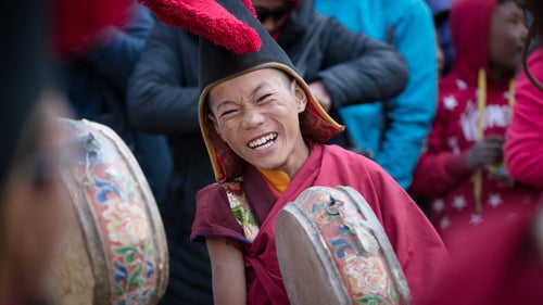 A young monk is caught off guard by the sound of an explosion during the Tiji Festival’s final evening.
