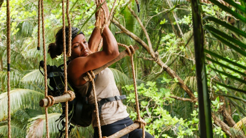Maria transitioning from the rope to the ladder.