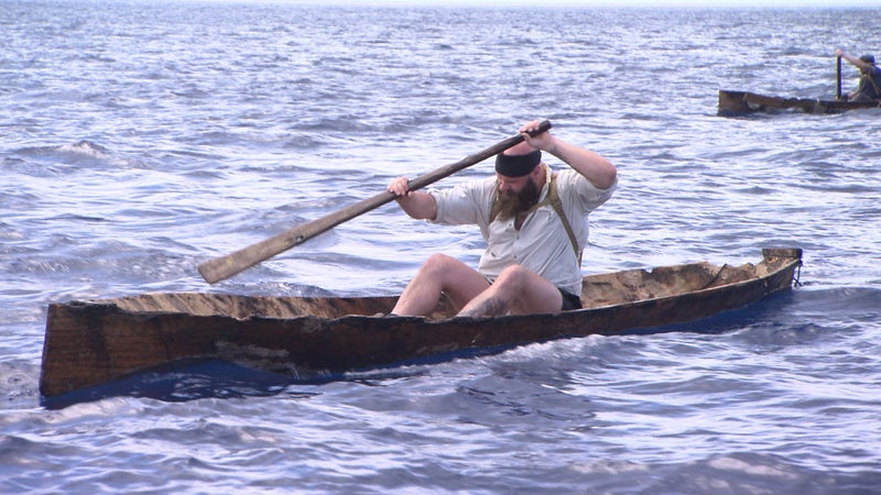 Brandon paddles fast and strong to try and reach the island.