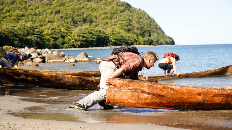 Derek pushing his canoe into the water.