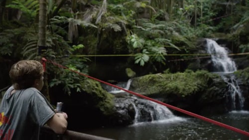 At just 19 years old, Alex Mason is one of the youngest phenoms in slacklining. He’s traversed the globe to compete, winning the Teva World Cup and the Slackline World Championships, all before he graduated high school. For his biggest project yet, he teamed up with his mentor, “Sketchy” Andy Lewis, and a Redbull film crew to trickline his way through the world’s first “slackladder” — a term coined by Redbull. In June, their crew of about 25 people headed for Hawaii’s Big Island to spend four days constructing the ladder, a series of 12 slacklines and other obstacles strung together to ascend a waterfall.
A far cry from the loud slackline competitions Mason is used to, the jungle of Hilo provided a serene backdrop for one of the coolest slackline videos we’ve ever seen. ԹϺ caught up with Mason and Lewis to learn more about their motivation for the project, and find out what’s next for the sport of slacklining.
Photo: Mason mentally prepares to take on the slackladder. It has 12 interconnected lines, for a total length of more than 2 miles.