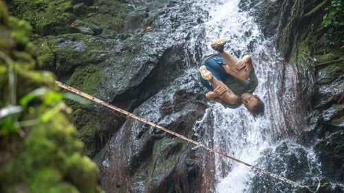 Alex Mason tricklines through Onomea Falls. He makes it look easy, but one misstep could mean a rough landing on the rocks.