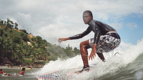 Another one of Surf Haiti鈥檚 top contenders catches a small wave in shallow water.