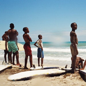 Haiti would be a rare sight on anyone's list of surfing hotspots. Despite beautiful beaches and solid breaks, the country is better known as a poster child for the failure of international aid in the wake of two devastating natural disasters—not to mention issues of violence, disease, and endemic corruption that persist today. However, since 2010 a small group of aid workers has been teaching local kids to surf the waves of Kabic Beach, roughly 45 minutes outside of Haiti's cultural capital, Jacmel. Many of these kids, despite growing up on the water, first had to learn to swim. 
This April, Surf Haiti hosted the country’s first surf competition matching up against a team from the bordering Dominican Republic. Photographer Mike Magers was there to capture the event, and what turned out to be a non-stop beach celebration. 
 Photo:  Contestants and spectators anxious to get back in the while water watching the heats from the beach.