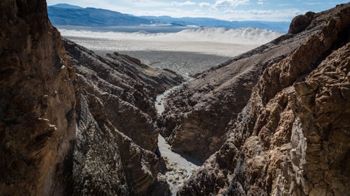 Eureka Dunes from Hammer Mjolnir Canyon. May 24, 2016.
Extreme conditions leave much of the park unpopular, unvisited, and undisturbed but full of splendid beauty. And while there are fewer 鈥渇irsts鈥 available to true adventurers, Death Valley has in the past decade provided a select group of canyoneers the opportunity to rack up hundreds of spectacular first descents through the park鈥檚 dramatic canyons. Of these first descenders, Scott Swaney, 68, has distinguished himself as particularly committed to exploring, logging, and naming all of Death Valley鈥檚 numerous canyons.