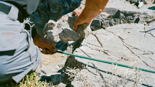 Swaney smooths a sharp rock lip so it won鈥檛 cut the rope. Cyclops Canyon, May 3, 2016.
So many things can go wrong that when I am finally leaning backwards over the edge of my very first canyoneering rappel, I have to adopt a mind-set of pure faith. Behind me is a 160-foot drop. In front of me is a gnarled knee-high tree with a loop of webbing around it. I trust Swaney. I trust Plummer, who has already descended this section and is waiting below, backing me up with a fireman鈥檚 belay. I trust the others and their decades of combined experience. I trust this tiny tree. And I do trust myself to stay calm and execute a proper rappel. Swaney reminds me to never, ever let go of the brake rope in my right hand. Otherwise, I鈥檒l zip straight down the line and die on impact.