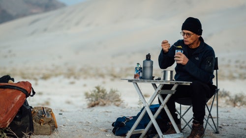 Swaney eating breakfast below the Eureka Dunes. May 21, 2016.
I learned about Swaney from a good friend who鈥檚 been following him on Facebook, fascinated by stories and photos of huge rappels, remote natural bridges, slick rock dryfalls, and rattlesnakes. My friend and I have been exploring Death Valley regularly for 15 years, and we鈥檝e had many hikes end abruptly at the foot of an impassible canyon dryfall.
I reached out to Swaney via Facebook, and he quickly replied within minutes with a thumbs-up emoji. Then: 鈥淵ou will have to join up. Been going every weekend this season. Lots of new canyons to check out.鈥 One month later, I鈥檓 riding in his dust-coated Nissan Pathfinder, heading from Los Angeles to Death Valley, while he gives me lessons on rappelling.