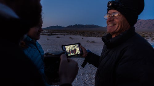 Swaney shows Navarro and Plummer the route of the first descent we鈥檒l attempt. May 3, 2016.
The next morning, we鈥檙e up before the sun and hike in the dark for two miles while Swaney鈥檚 GPS shows zero feet of elevation gain. Our group: Jared Plummer, Stephanie Navarro, me, Aysel Gezik, and Scott Swaney. I鈥檓 the only one without multiple first descents under my belt. Around sunrise, we reach an alluvial fan dotted with fragrant creosote bushes and finally begin to gain some altitude. 鈥淲hat he did is a pretty cool thing,鈥 Swaney muses about Buzz Aldrin. He says Neil Armstrong gets all the credit, but Buzz was right there with him. And yet there can only be one first.