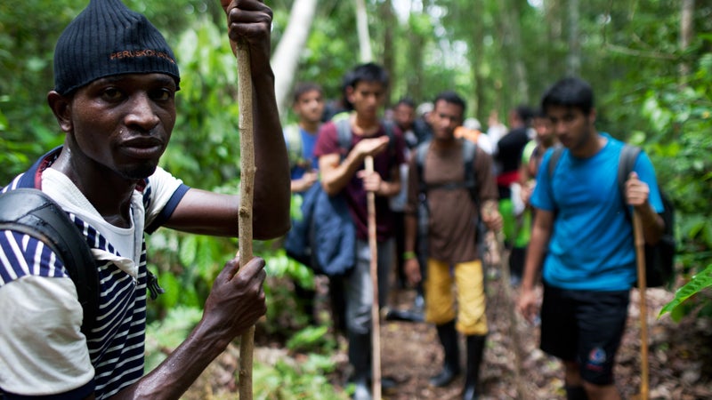 Gambian Morro Kanteh with fellow migrants from Bangladesh and Nepal in the Dari茅n Gap.